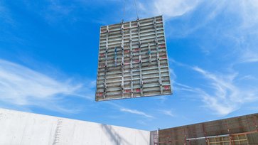 Elementverbund der Master PRO Stahlrahmenschalung wird per Kran verhoben